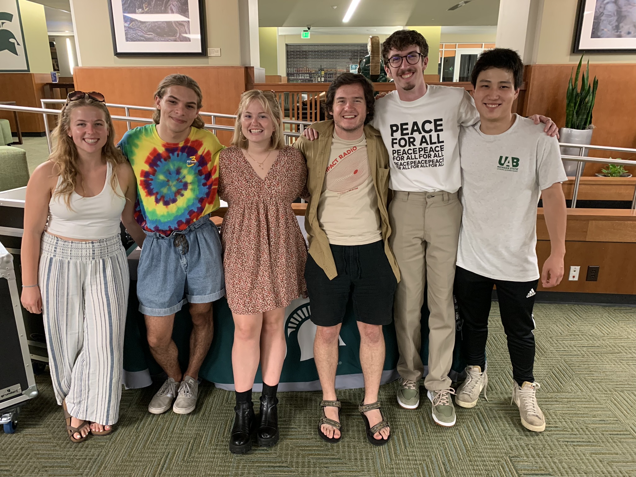 UAB and Impact student team members stand together in the Union Main Lounge